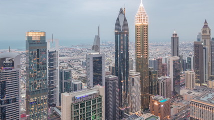  Skyline of the buildings of Sheikh Zayed Road and DIFC aerial day to night timelapse in Dubai, UAE.