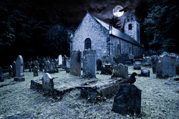 old graveyard with ancient tombstones grave stone and old church front of full moon black raven dark night spooky horror background