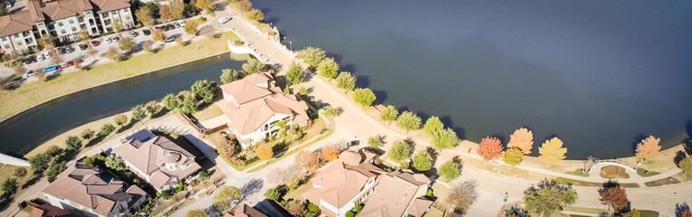 Wall Mural - Panoramic aerial view new construction lakeside suburban house bright autumn orange color Dallas