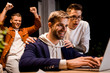 © LIGHTFIELD STUDIOS - happy businessmen looking at laptop while working at night in office