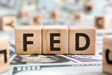 FED - Acronym From Wooden Blocks With Letters, Abbreviation FED Federal Reserve System Or Federal Agent Concept, Random Letters Around, Money Background