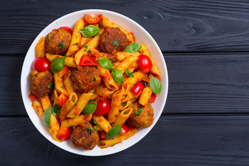 Canvas Print - Italian penne pasta with meatballs and tomatoes