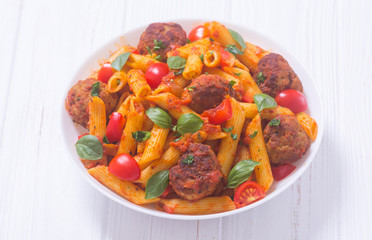 Canvas Print - Italian penne pasta with meatballs and tomatoes