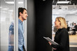 © FOLIO - Coworkers talking in office