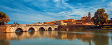 Tiberius Bridge In Rimini On A Background Of Blue Sky With White Clouds