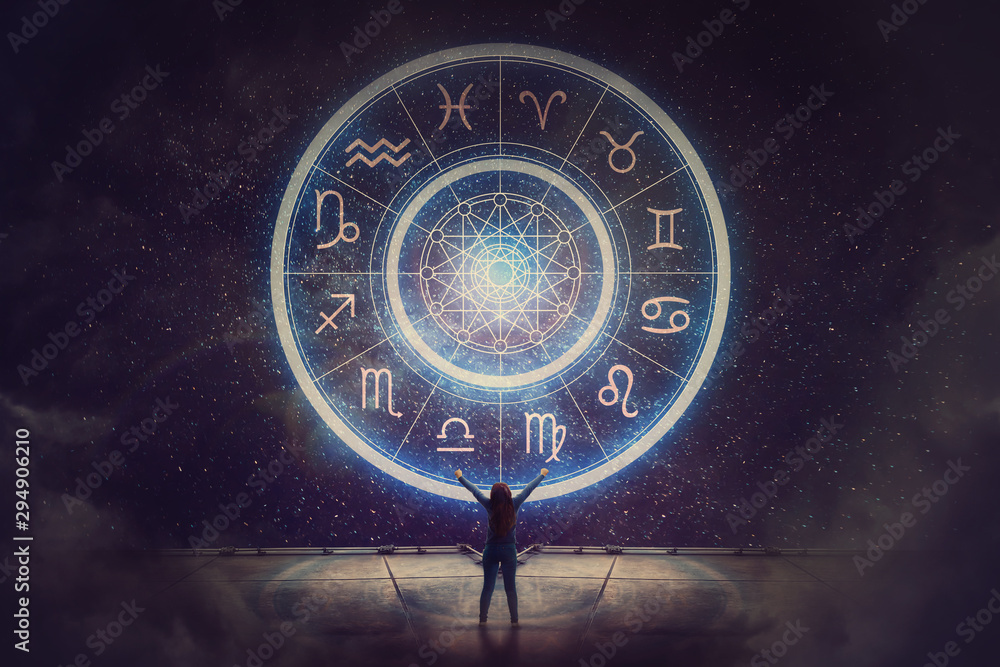 Woman raising hands looking at the night sky. Astrological wheel projection, choose a zodiac sign. Trust horoscope future predictions, consulting stars. Power of universe, astrology esoteric concept. - obrazy, fototapety, plakaty 