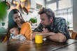 © Westend61 - Family with baby sitting at kitchen, table at home