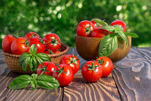 Cherry Tomatoes And Basil On Wooden Board Outdoors