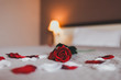 canvas print picture -  Rose on the bed in the hotel rooms. Rose and her petals on the bed for a romantic evening