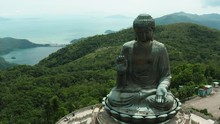 Aerial Shoot Of Tian Tan Buddha In Hong Kong, Huge Statue And Amazing Nature Around It, Hills And Forests Of Hong Kong Countryside
