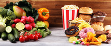 Healthy Or Unhealthy Food. Concept Photo Of Healthy And Unhealthy Food. Fruits And Vegetables Vs Donuts And Fast Food