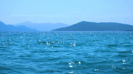 Poster - Sea water with soft waves at summer noon and sail yacht on the horizon, Saronic Islands, Greece