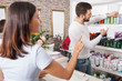 © JackF - Young man hairstylist  advise woman client  in cosmetics studio