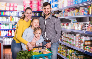 Laughing family of four with full basket