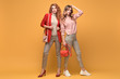 © evgenij918 - Fashion. Two Beautiful woman in autumn red pink clothes, trendy hair, make up. Adorable well dressed girl, friends on orange. Creative fashionable lady hipster style, beauty spring full length shot