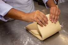 Chef Hands Making And Folded Raw Puff Pastry. Making Puff Pastry.   On A Stainless Steal Table. First Step, Dough And The Butter On The Table.Close Up. Pastry Chef. How To Make.