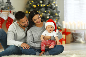 Wall Mural - Happy family with cute baby at home. Christmas celebration