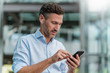 © Westend61 - Businessman with earphones and cell phone in the city