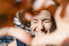 Woman With Straw Hat, Looking Into The Sun, Making Heart Shaped Finger Frame