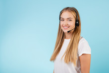 Friendly Smiling Blonde Call Center Operator With Headset Isolated Over Blue