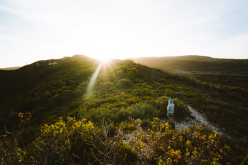 girl standing alone in the australian wilderness on the bibulman hike trail, albany, western austral