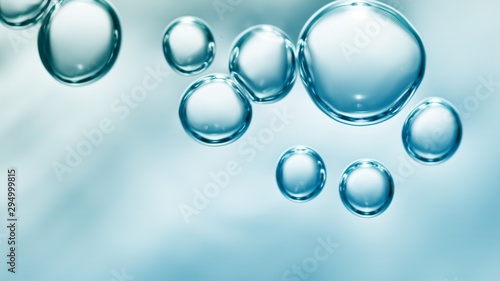 transparent gas bubbles on water surface. Worms-eye low angle with crystal bubbles in purified water on blue background. cosmetic background with copy space
