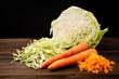 © Natallia - Fresh cabbage and carrot on dark wooden background.