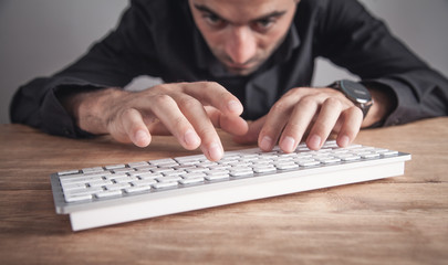 Wall Mural - Businessman typing on computer keyboard.