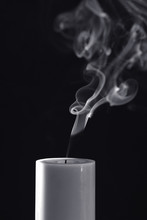 White Candle With White Smoke On Black Background