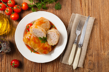 Wall Mural - Traditional stuffed cabbage with minced meat and rice, served in a tomato sauce.