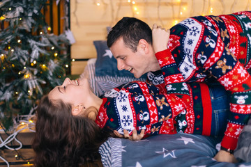 closeup of girl and boy lying and smiling on bed. near the bed a