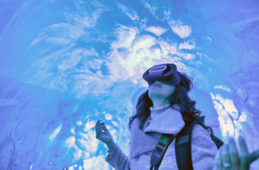 Canvas Print - Woman with 3D glasses visor enjoying the view of Iceland ice cave