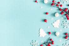 Christmas Or Winter Composition. Snowflakes And Red Berries On Blue Background. Christmas, Winter, New Year Concept. Flat Lay, Top View, Copy Space