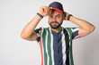 © Ranta Images - Portrait of young handsome bearded Indian man wearing hat