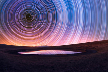 Wall Mural - beautiful night landscape, old volcano, crater lake. the colorful star trails on the sky. night time
