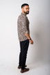 © Ranta Images - Full body shot rear view of young bearded Indian man thinking