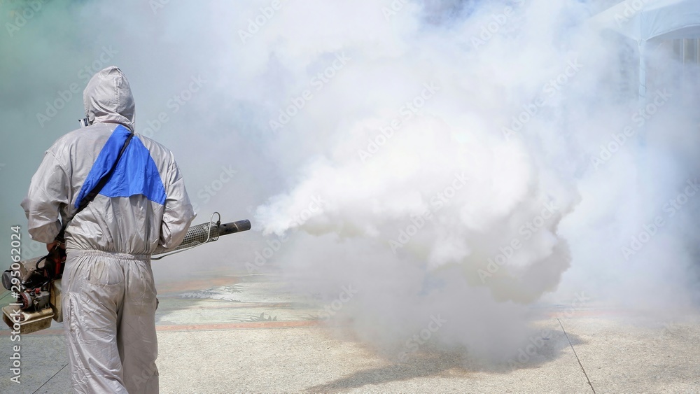Rear view of  outdoor healthcare worker using fogging machine spraying chemical to eliminate mosquitoes and prevent dengue fever at general location in community - obrazy, fototapety, plakaty 