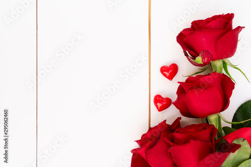 Red blooming roses on wood