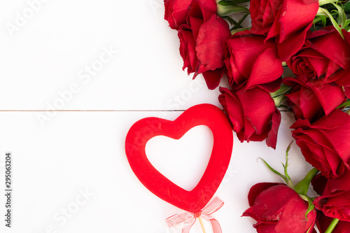 Red blooming roses on wood