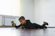 © Ivan - Little boy lying on stomach during physiotherapy. Do some exersice, have some health problems.