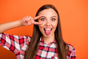 Sticker - Close-up portrait of nice attractive cheerful cheery straight-haired girl wearing checked shirt showing v-sign tongue out having fun isolated on bright vivid shine vibrant orange color background