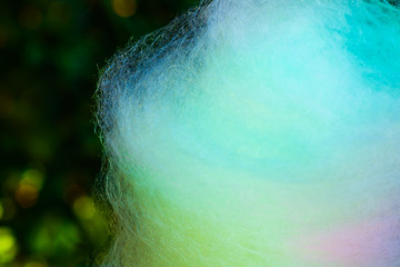 Abstract rainbow cotton wool texture closeup. Sweet kids sugar dessert detail on merry go round summer fair. Macro photography in neo noir style, unhealthy food and lifestyle, white poisons concepts.