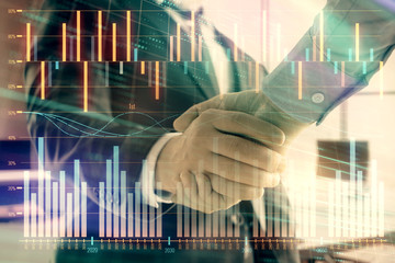 Multi exposure of financial graph on office background with two businessmen handshake. Concept of success in business