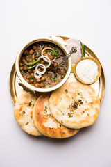 Wall Mural - Pindi Chole Kulche or roadside choley Kulcha popular in India and pakistan is a popular streetfood. It's a spicy Chickpea or chana curry served with Indian Flat Bread. selective focus