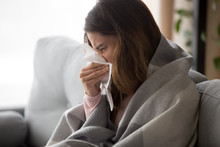 Ill Young Woman Covered With Blanket Blowing Nose Got Flu