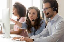 Call Center Female Worker Helping To Man New Employee Colleague