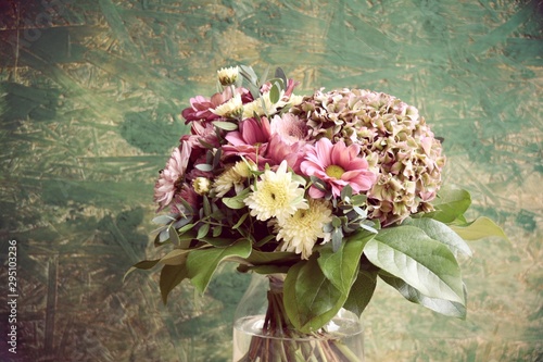 Schöner Blumenstrauß mit Herbstblumen vor rustikalem grünem Hintergrund