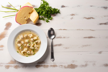 Fresh capeletti soup; Capeletti in brodo - Italian cuisine, soft light, copy space