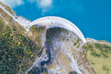 Hydroelectricity Generated From Water Dam And Reservoir Lake In Swiss Alps Mountains To Produce Renewable Energy And Limit Global Warming, Sustainable Development With Hydropower, Aerial Drone Photo