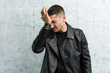 © Asier - Young rocker man forgetting something, slapping forehead with palm and closing eyes.